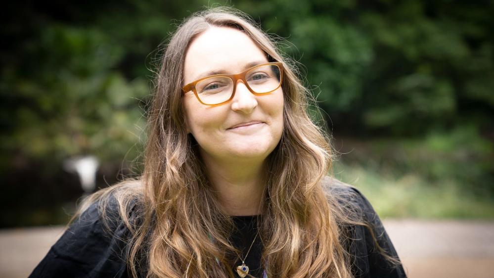 Sarah Keech from the Disability and Inclusion Network smiles at the camera. She wears glasses and has long brown hair. Photo: Paul Jones